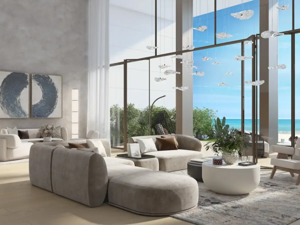 Double-height living room with Arabian Gulf view at Beach House at Bay Residences