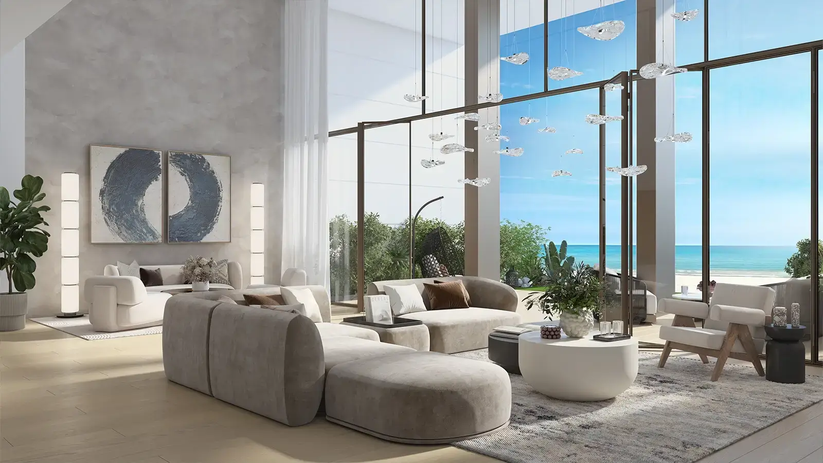 Double-height living room with Arabian Gulf view at Beach House at Bay Residences